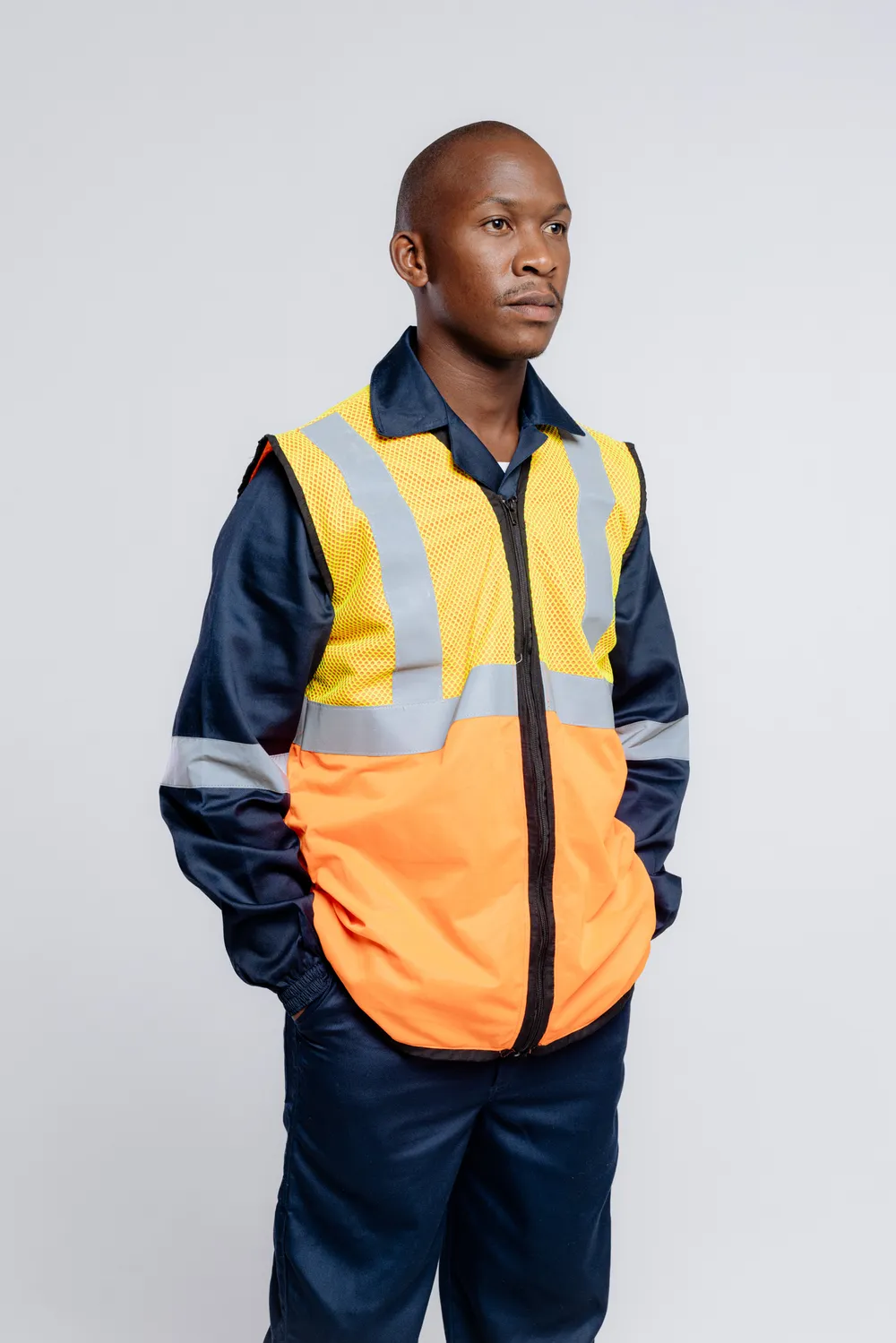 Worker in PPE and hi-vis jacket